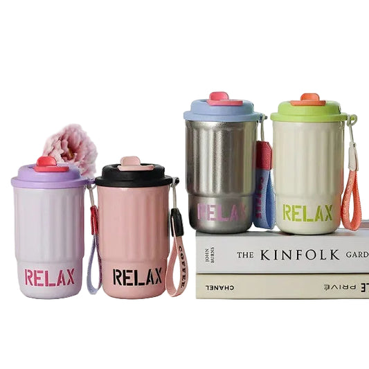 Set of colorful 'RELAX' water bottles with straps on a surface with books and flowers in the background.
